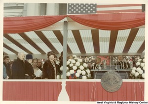 Governor Arch Moore standing behind the podium watching his wife Shelley arrive on the platform.