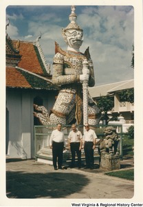 Governor Arch Moore (center) with two unidentified men. They are standing in front of a Yaksha statue at the Grand Palace in Bangkok, Thailand