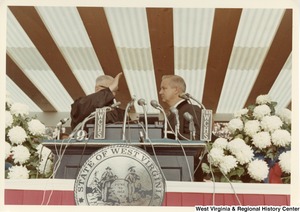 Governor Arch Moore being sworn into office by an unidentified man.