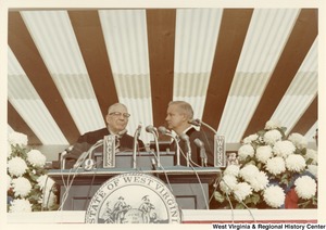Governor Arch Moore being sworn into office by an unidentified man.