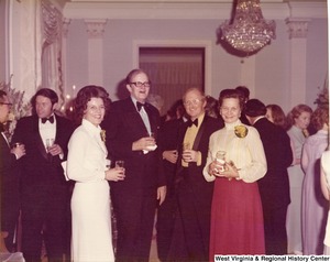 Two unidentified men and two unidentified women at a reception.