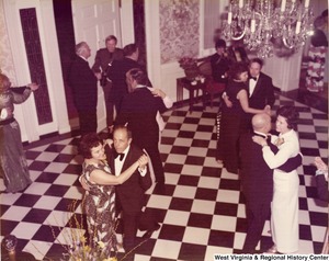 Five unidentified couples dancing at a reception.