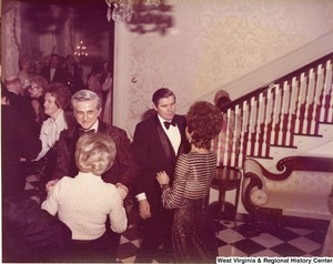 A group of people mingling at a reception.