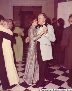 An unidentified man and woman dancing at a reception.