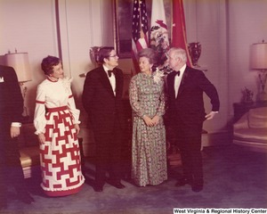 Governor Arch Moore and his wife Shelley talking to an unidentified man and woman at a reception.