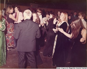 A large group of people dancing at a reception.
