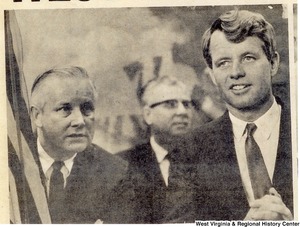 Congressman Arch Moore speaking to Robert Kennedy. An unidentified man can be seen between them in the background.