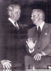 Governor Arch Moore speaking to Senator Robert C. Byrd before his appearance before a Senate panel on energy and water development. Moore thanked the panel for its support of the Appalachian Regional Commission.