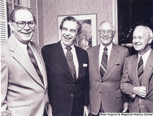 Governor Arch Moore (first on right) standing with three unidentified men.