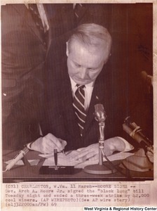 Governor Arch A. Moore signing the Black Lung bill (House Bill No. 1040) that ended a three-week strike by 42,000 coal miners. This was the first legislation in the country recognizing black lung as a compensable occupation disease.