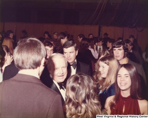 Governor Arch Moore in the middle of a crowd of people at a party.