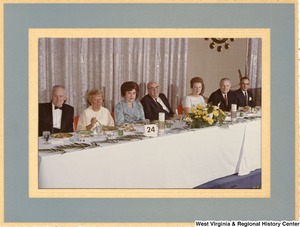Congressman Arch Moore (second from the right) eating with an unidentified group of men and women.