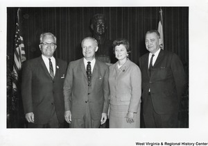 Arch Moore (center left) and Shelly Moore (center right) with two unidentified men in front of a bust of President John F. Kennedy.