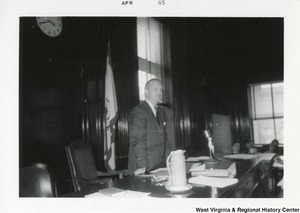 Congressman Arch Moore leaning against a desk.