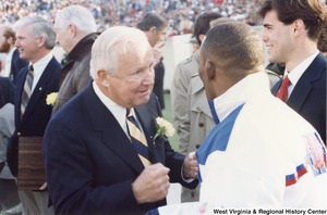 Governor Arch Moore speaking to Olympic wrestler Nate Carr (second on the right) and sports shooter Webster Wright (first on the right).
