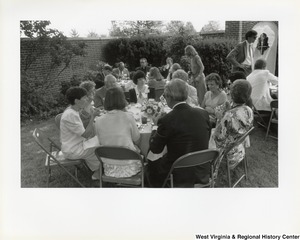 An unidentified group of people eating outside during West Virginias 125th birthday party.