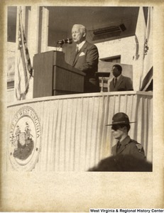 Governor Arch Moore speaking at a podium during his inauguration as governor.