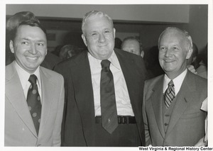 Governor Arch Moore (right) standing with two unidentified men.