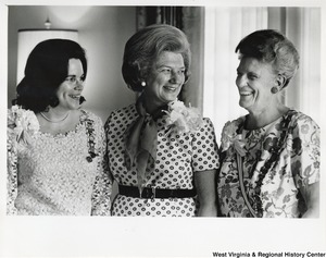 Shelley Moore (center) standing with two unidentified women. The two women are wearing a ribbon with pins on it.