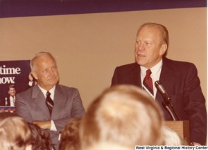 Gerald Ford speaking during Archs campaign rally for governor. Arch Moore is standing to the left of Ford.