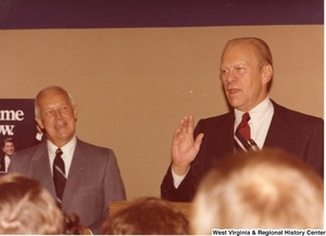 Gerald Ford speaking during Arch Moores campaign rally for governor. Arch is standing to the left of Ford.