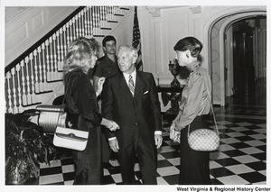 Governor Arch Moore (center) speaking to two unidentified women. An unidentified Police Officer is standing in the background.
