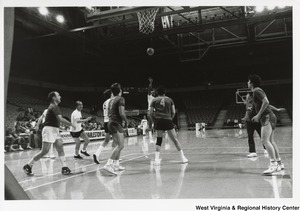 The Charleston Gunners playing a game on the basketball court. In the background, Governor Arch Moore (white track suit) can be seen standing on the side of the court.
