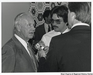 Governor Arch Moore being interviewed by two unidentified men from Channel 13.