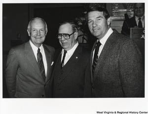 Governor Arch Moore (first on left) standing with two unidentified men.