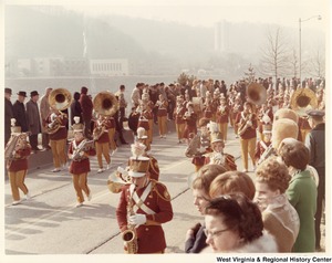 An unidentified high school marching band during Governor Arch Moores inaugural parade in Charleston. The band is wearing red and yellow uniforms.