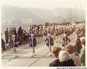 An unidentified high school marching band during Governor Arch Moores inaugural parade in Charleston. The band and majorettes are wearing blue and white uniforms.