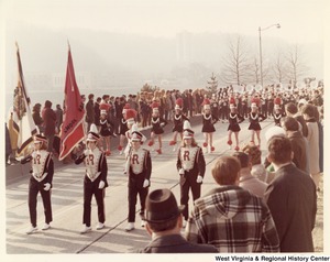 An unidentified high school marching band during Governor Arch Moores inaugural parade in Charleston. The band is wearing black, white, and red uniforms with a red R on the chest.