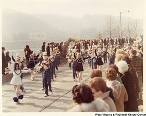 An unidentified high school marching band during Governor Arch Moores inaugural parade in Charleston. The band is wearing blue and white uniforms.