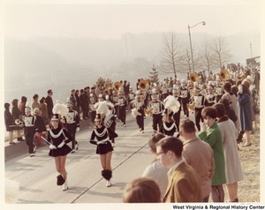 An unidentified high school during Governor Arch Moores inaugural parade in Charleston. The band is wearing black and white uniforms with DHS on the chest.