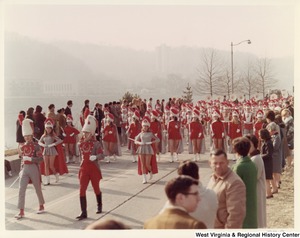 An unidentified high school during Governor Arch Moores inaugural parade in Charleston. The band and majorettes are wearing red and white uniforms.