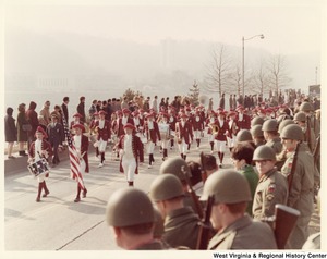 An unidentified high school during Governor Arch Moores inaugural parade in Charleston. The band is wearing red and white uniforms.